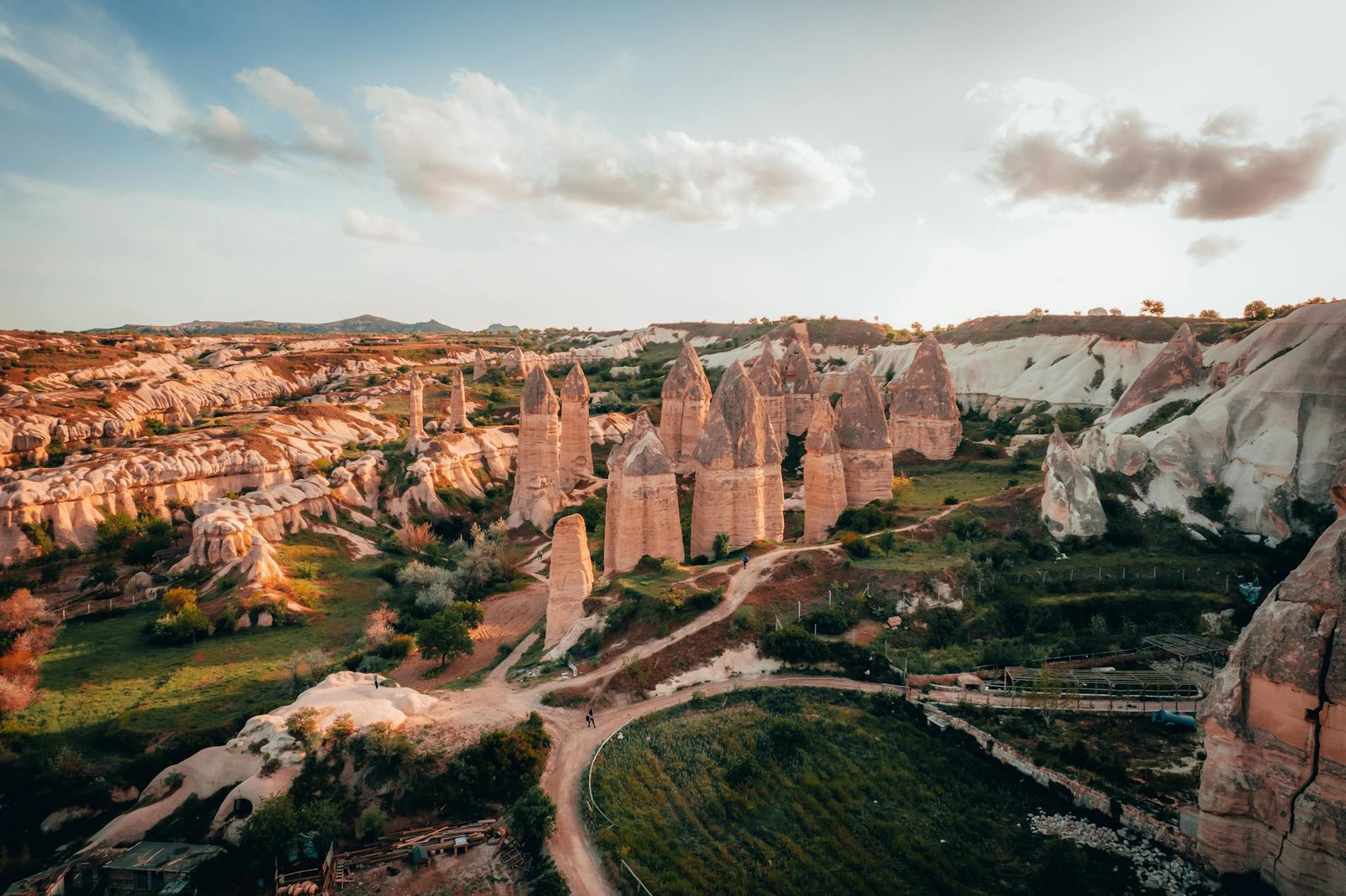 Aerial view of Cappadocia's iconic rock formations at sunset, Turkey's natural wonders.